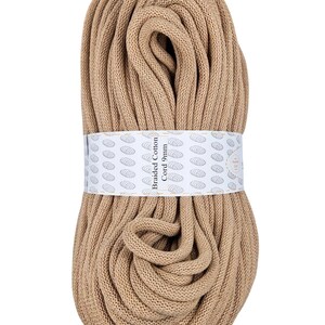 May include: A roll of beige braided cotton cord, 9mm thick. The label reads "Braided Cotton Cord 9mm".