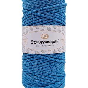 May include: A spool of bright blue cotton cord, perfect for crafting. The label reads "Sznurkomania Pasja tworzenia" and features a stylized image of a ball of yarn.