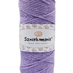 May include: A spool of lavender colored cotton rope with silver glitter thread woven throughout. The spool is labeled "Sznurkomania Pasja tworzenia".