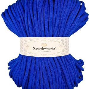 May include: A large spool of bright blue cotton cord, perfect for crafting. The cord is wound tightly and has a smooth texture. The label on the spool reads "Sznurkomania Pasja tworzenia".