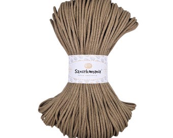 May include: A spool of brown cotton cord, wrapped in a white label with the text "Sznurkomania" and "Pasja tworzenia".