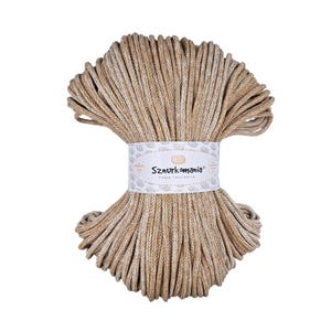 May include: A close-up of a beige and white cotton cord, wound into a coil. The cord is labeled "Sznurkomania" with the text "Pasja tworzenia" underneath.