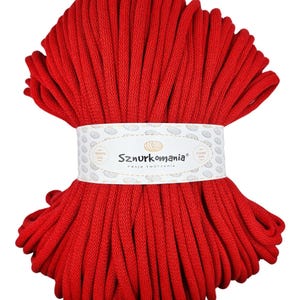 May include: A large spool of bright red cotton cord, labeled "Sznurkomania" with the tagline "Pasja tworzenia".