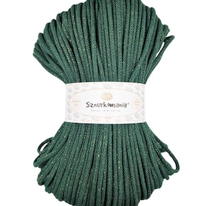 May include: A spool of dark green cotton cord with gold glitter woven throughout. The cord is labeled "Sznurkomania" with the tagline "Pasja tworzenia".