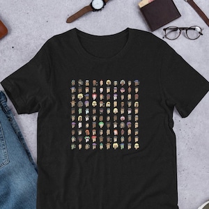 May include: A black t-shirt with a pattern of colorful pixelated faces. The faces are arranged in a grid pattern and are all different.