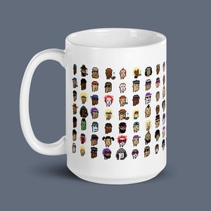 May include: White ceramic mug with a design of colorful pixelated faces. The mug has a black handle.