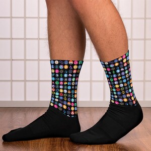 May include: A pair of black socks with a colorful pattern of cryptocurrency logos. The socks are made of a soft, comfortable material and are perfect for everyday wear.