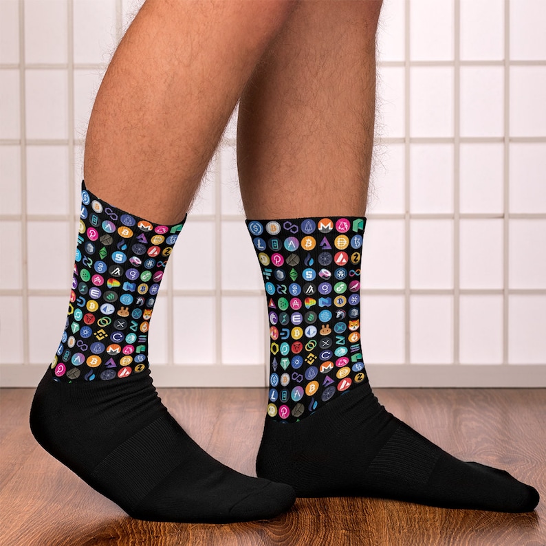 May include: A pair of black socks with a colorful pattern of cryptocurrency logos. The socks are made of a soft, comfortable material and are perfect for everyday wear.