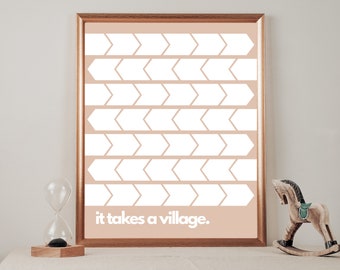 May include: A framed print with a peach background and a white geometric pattern of arrows. The text "it takes a village." is printed at the bottom of the print.
