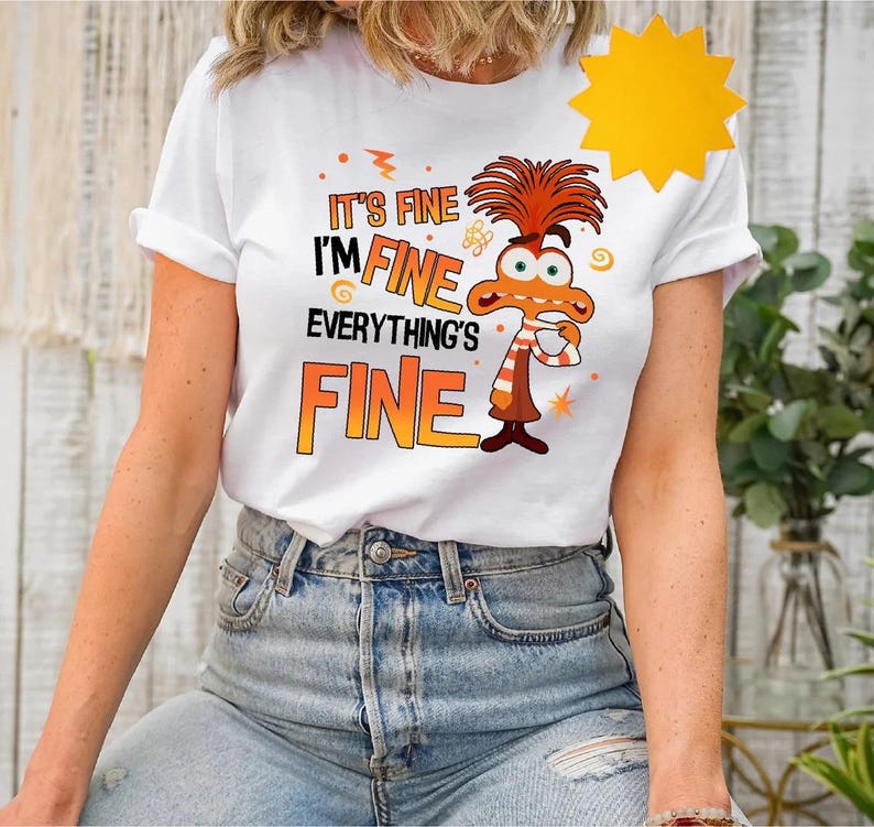 May include: White t-shirt with a cartoon character and the text "It's fine I'm fine everything's fine".