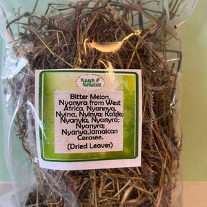 May include: A clear plastic bag filled with dried, brown, and green leaves. The bag has a label that reads "Naash Naturals Bitter Melon, Nyanyra from West Africa, Nyannya, Nyina, Nyinya; Kakle; Nyanyla, Nyanyra; Nyanyra; Nyanya, Jamaican Cerasee. (Dried Leaves)"