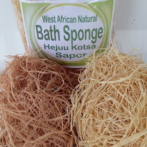 May include: Two natural bath sponges, one light brown and one light yellow, in a wicker basket. The sponges are made from the fibers of the West African natural bath sponge, also known as Hejuu Kotsa Sapor.