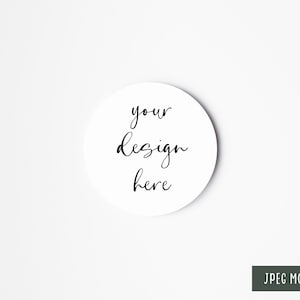 May include: White round coaster mockup with the text "your design here" in black cursive writing.