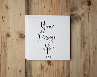 May include: A white card with the text "Your Design Here 8 x 8" printed on it. The card is sitting on a wooden surface.