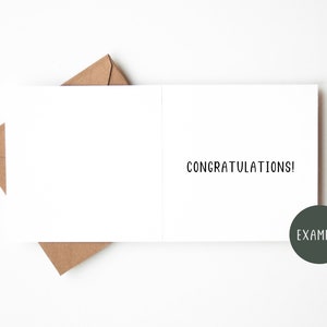 May include: A blank white card with a brown envelope on the left side and the word "CONGRATULATIONS!" printed on the right side. The word "EXAMPLE" is printed in a circle on the bottom right corner.