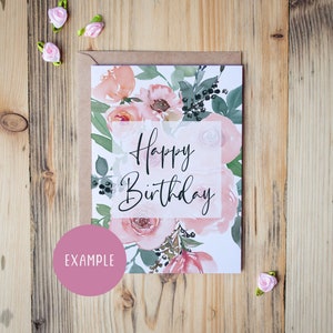 May include: A white card with a floral design in shades of pink and green. The card says "Happy Birthday" in black script.