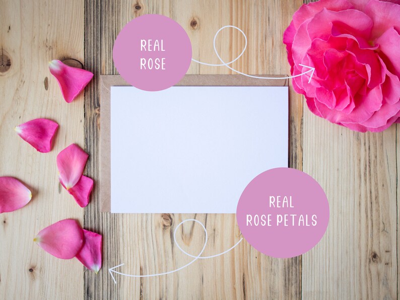 May include: A white card with a blank space for writing, surrounded by real rose petals and a real rose. The text "REAL ROSE" is written on a pink circle above the card and the text "REAL ROSE PETALS" is written on a pink circle below the card.