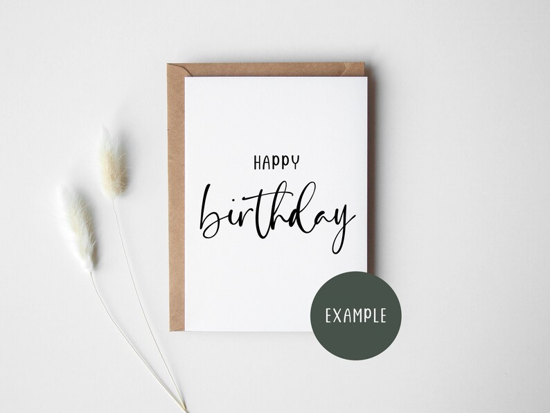 May include: A white card with a black handwritten message that says "Happy birthday". The card is on a brown envelope and a white background.