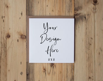 May include: A white card with brown paper backing on a wooden surface. The card has the text "Your Design Here 8 x 8" printed on it.