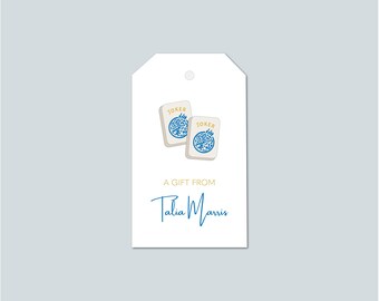 May include: White gift tag with two "Joker" playing cards featuring blue floral designs. The tag includes the text "A Gift From Talia Marris" in blue script.