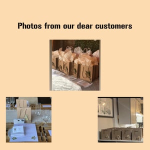 May include: A collection of brown paper gift bags with white tissue paper and floral embellishments. The bags are arranged on a white table with a white tablecloth. The bags are decorated with the word "Bride" and a floral design.