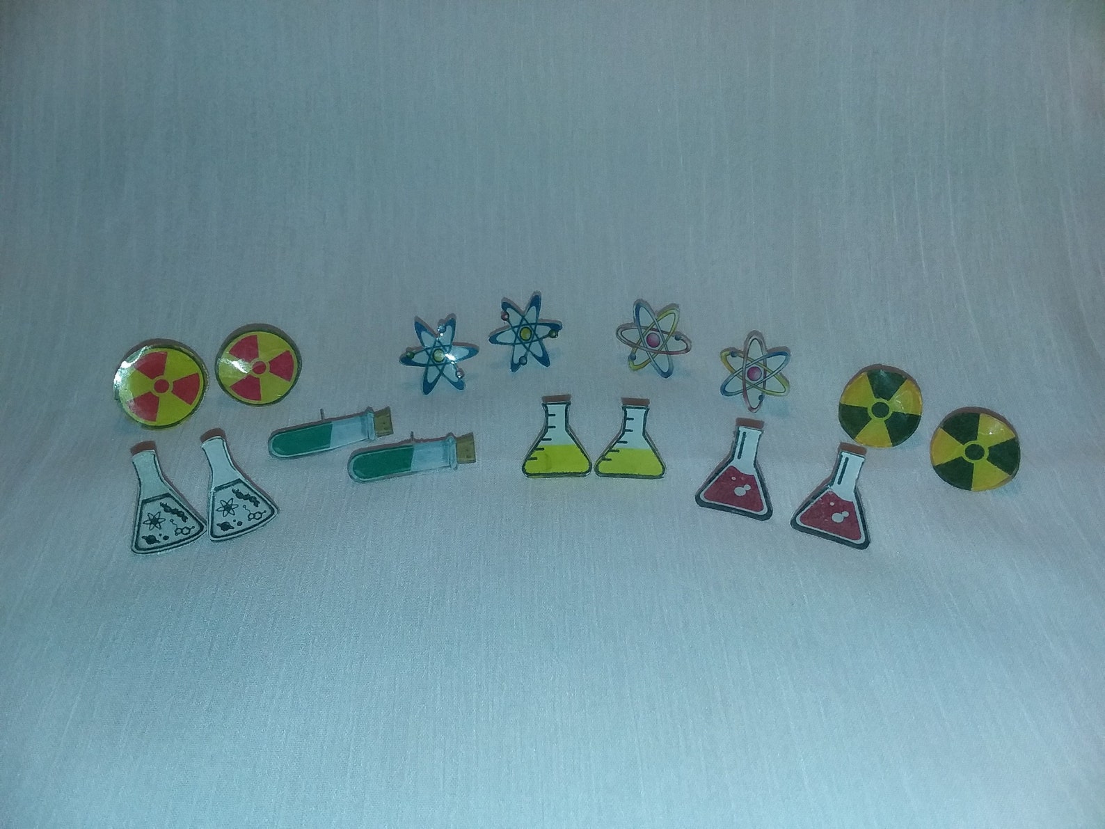 Science Geeks Celebrate Back to School With New Science Icon Earrings Molecules, Radiation Signs