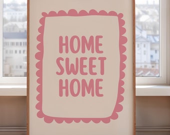 Puede incluir: Una impresión enmarcada con un fondo beige claro y un borde rosa festoneado. El texto "HOME SWEET HOME" está escrito en rosa dentro del borde.