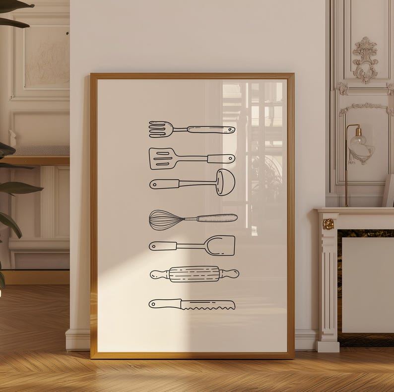 May include: A framed print featuring a collection of kitchen utensils in a minimalist style. The black line art includes a fork, spatula, whisk, rolling pin, and knife, all against a neutral background. The print is displayed in a room with a wooden floor.