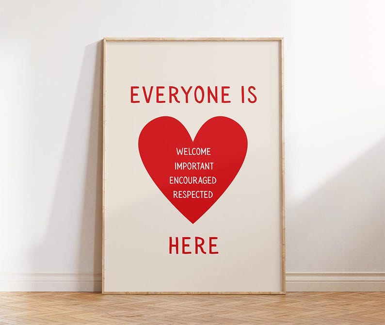 May include: A framed print with a cream background and red text. The text reads "EVERYONE IS HERE" with a red heart in the center containing the words "WELCOME IMPORTANT ENCOURAGED RESPECTED". The frame is a light wood color.