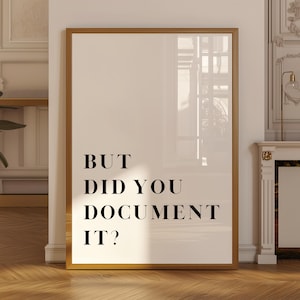 May include: A rectangular wall art print in a thin brown frame featuring a white background with the black text BUT DID YOU DOCUMENT IT? centred in a bold serif font. The print is displayed in a vertical orientation with clean lines.