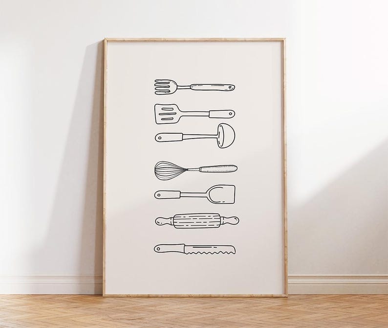 May include: A framed print featuring line drawings of various kitchen utensils, including a fork, spatula, ladle, whisk, turner, rolling pin, and bread knife. The utensils are black on a cream-colored background, creating a minimalist aesthetic.
