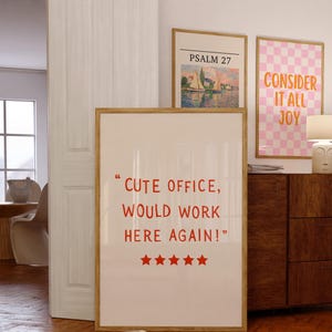 May include: Three framed art prints with text and images. The largest print has the text "CUTE OFFICE, WOULD WORK HERE AGAIN!" in red. The other prints feature the text "PSALM 27" and "CONSIDER IT ALL JOY".