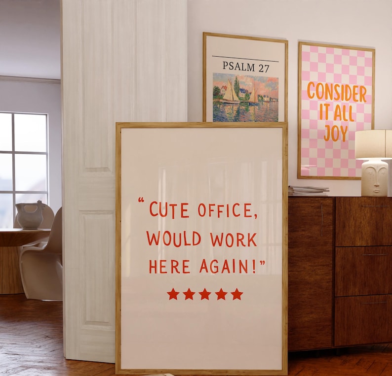 May include: Three framed art prints with text and images. The largest print has the text "CUTE OFFICE, WOULD WORK HERE AGAIN!" in red. The other prints feature the text "PSALM 27" and "CONSIDER IT ALL JOY".