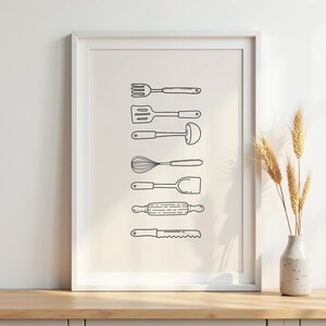May include: A framed print featuring line drawings of kitchen utensils, including a fork, spatula, ladle, whisk, turner, rolling pin, and knife. The black and white illustrations are arranged vertically on a cream-colored background.