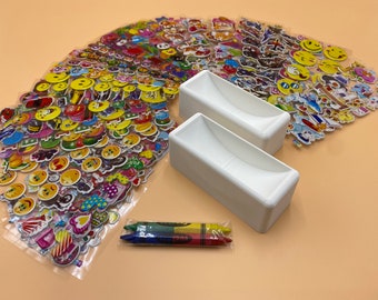 May include: A set of two white plastic containers with a curved top, a pack of three crayons, and a sheet of colorful stickers featuring smiley faces, hearts, and other designs.