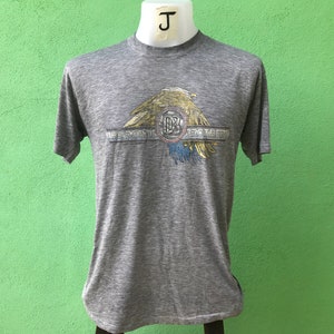 May include: A gray t-shirt with a vintage-style graphic of an eagle with the text "The Doobie Brothers" printed on it.