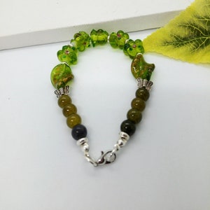 A green glass beaded bracelet, costume, girlfriend or boyfriend, man or woman present,sweetheart,graduation, retirement gift, appreciation