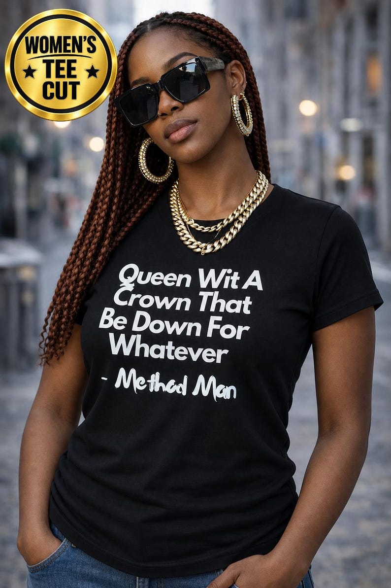 May include: A black short-sleeved t-shirt featuring white text that reads: Queen Wit A Crown That Be Down For Whatever - Method Man. The shirt has a crew neckline and a fitted cut, displayed with gold-toned hoop earrings and a layered gold chain necklace.
