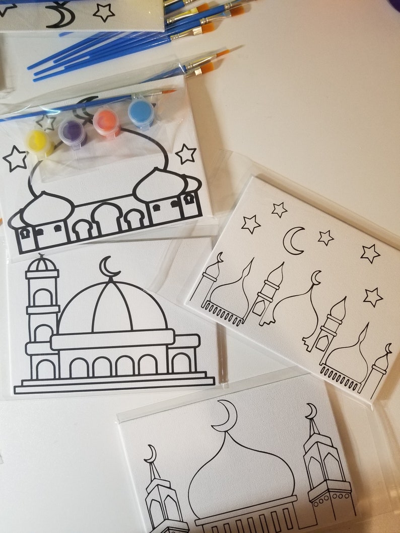 May include: A set of three paint-by-number canvases featuring mosque designs. Each canvas has a different mosque design with black outlines and white backgrounds. The set includes four small bottles of paint in yellow, purple, orange, and blue.