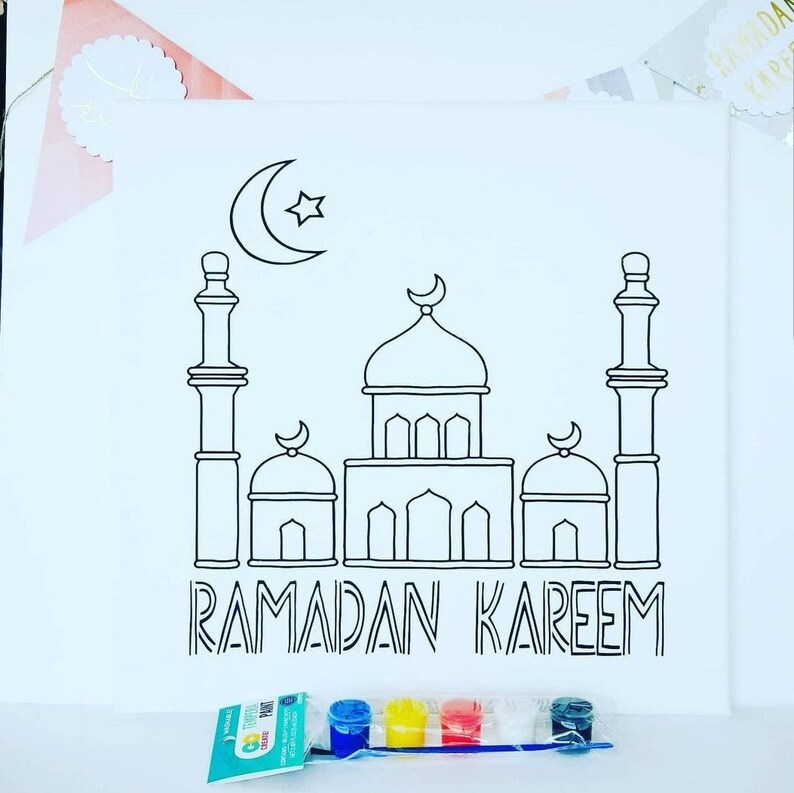 May include: A black and white outline drawing of a mosque with a crescent moon and star above it. The text "RAMADAN KAREEM" is below the mosque. A set of paintbrushes and paint pots are in the bottom right corner of the image.