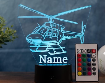 May include: A blue LED helicopter night light with the word "Name" at the base. The light has a remote control with color options. The helicopter design is etched into a clear acrylic panel.