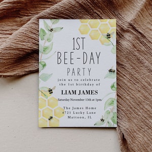 May include: A rectangular invitation with the text "1st Bee-Day Party" and "Liam James" printed on it. The invitation features watercolor illustrations of bees, honeycombs, and greenery. The invitation also includes the date, time, and location of the party.