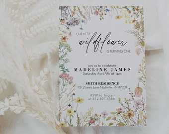 May include: A white invitation with a floral border. The text reads "Our Little Wildflower is Turning One" and includes the name Madeline James, the date and time of the event, and the location. The invitation also includes an RSVP request.