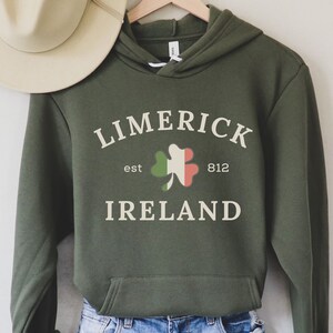 May include: A green hooded sweatshirt with the text "LIMERICK est 812 IRELAND" and a shamrock with the colors of the Irish flag.