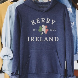 Op de afbeelding: Een marineblauw hoodie met de tekst "Kerry est 1300 Ireland" en een groene klaver met de kleuren van de Ierse vlag.