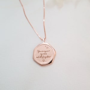 May include: Rose gold necklace with a pendant that reads "You are my sun, my moon, and all of my stars" with a small star and heart engraved on the pendant.