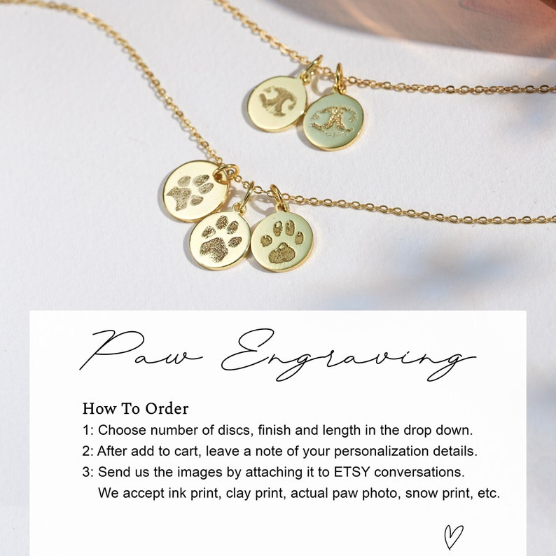 May include: Gold necklace with three round pendants featuring paw prints. The necklace is on a white background with text that reads "Paw Engraving" and instructions on how to order.