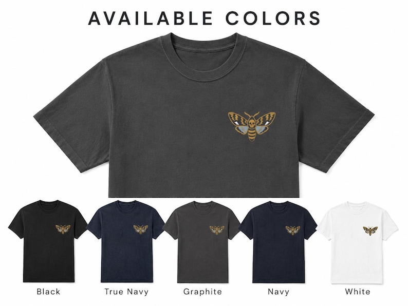 May include: A charcoal gray cropped t-shirt featuring a moth graphic with a skull pattern on the chest. Below, five t-shirts are displayed in black, true navy, graphite, navy, and white, each with the same moth graphic and color labels.