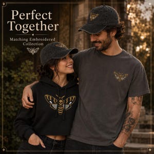 May include: A charcoal gray baseball cap, a black hooded sweatshirt, and a charcoal gray t-shirt, each featuring an embroidered moth design with a skull pattern. The text Perfect Together Matching Embroidered Collection is visible.