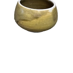 May include: A handmade ceramic bowl with a rounded shape and a wide opening. The exterior has a mottled, earthy green and brown glaze, while the rim is a clean white. The bowl is likely used for serving or display.